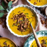 bowls of spiced butternut squash soup with granola on top